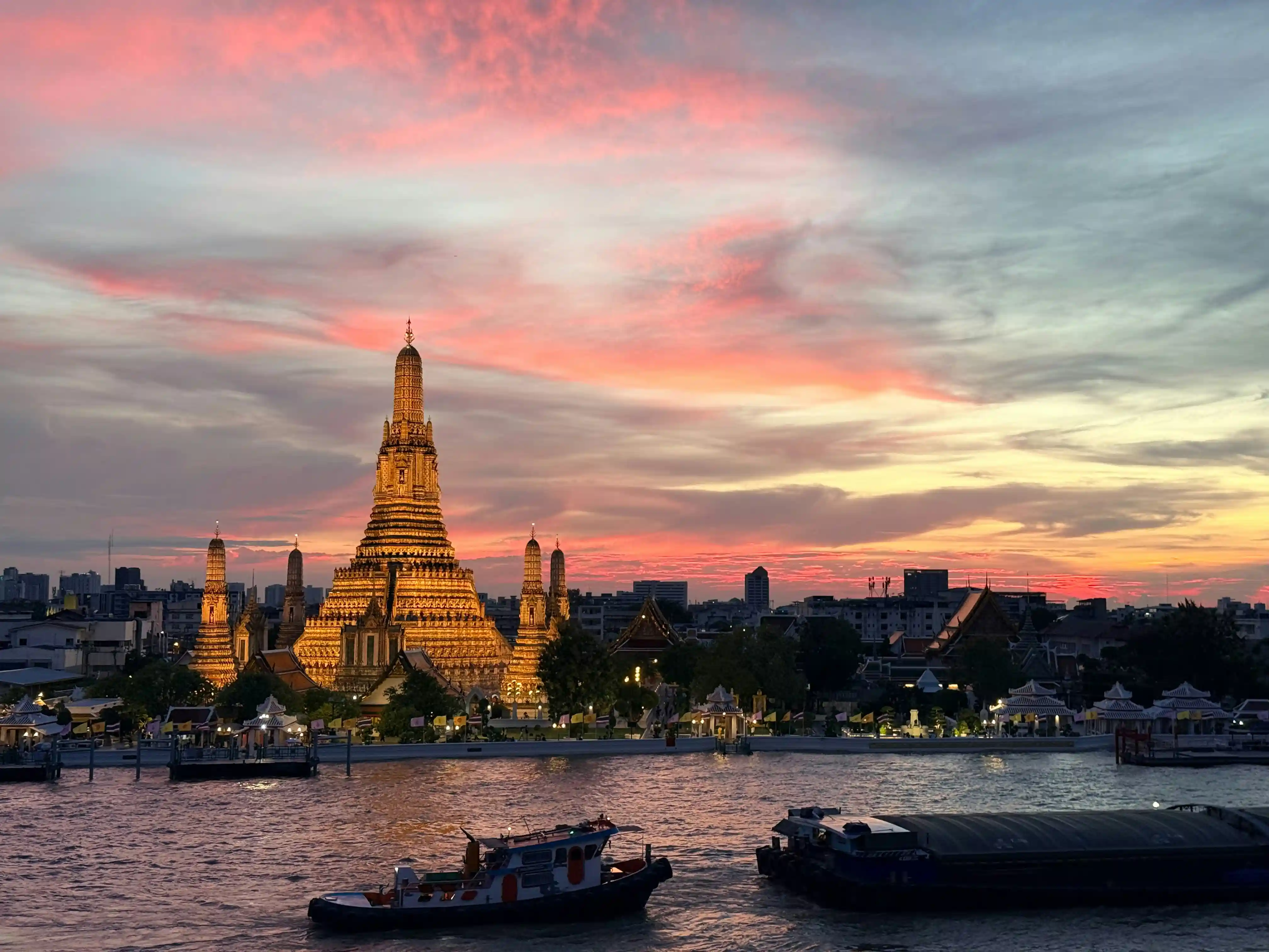 Wat Arun temple at sunset along the Chao Phraya River, Bangkok
